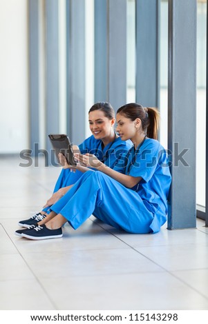 female nurses using tablet computer during break