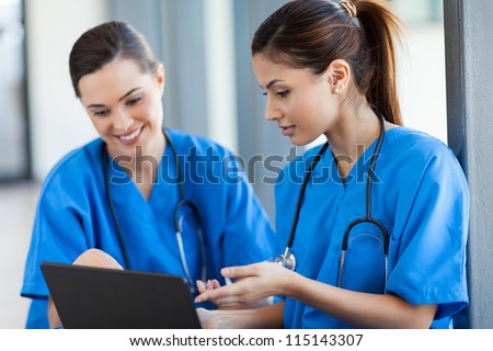 two beautiful female healthcare workers using laptop