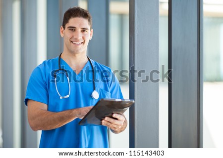 happy male healthcare worker with tablet computer