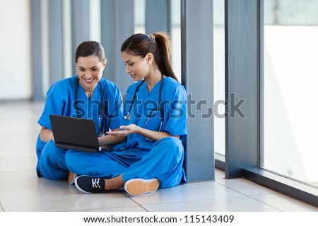 two nurses using laptop computer during break