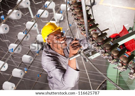 african american textile factory mechanic repairing machine