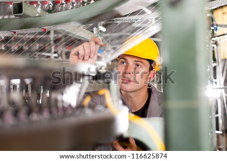 textile factory quality controller checking yarn