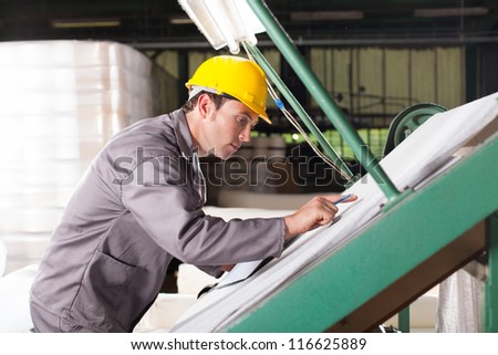 textile quality controller checking fabrics on QC table