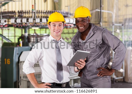 modern factory manager and worker with tablet computer