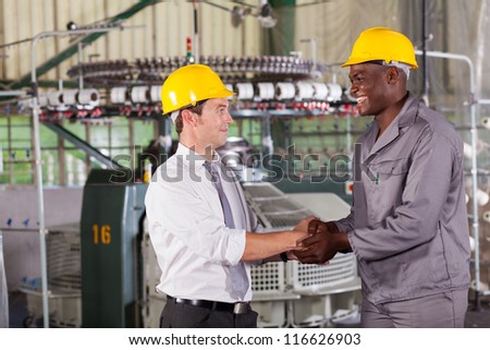 factory manager handshaking with african american worker