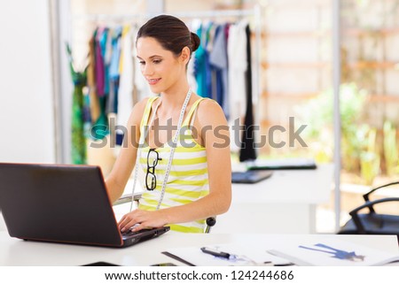 modern fashion designer sketching using laptop computer