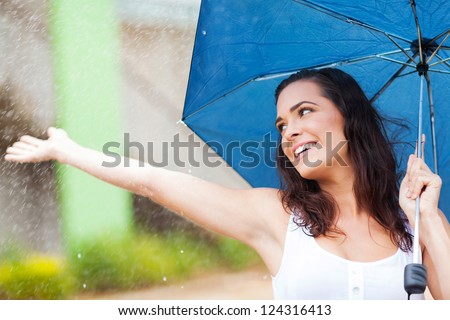 attractive young woman having fun in the rain