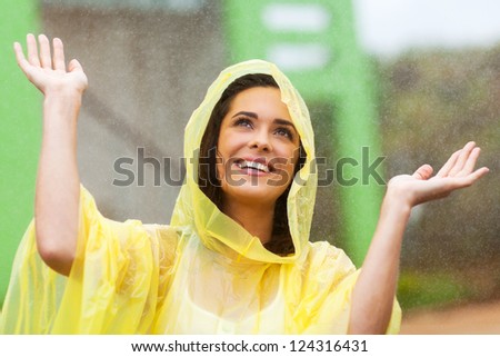 happy young woman playing in the rain
