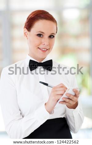 pretty waitress taking orders in restaurant