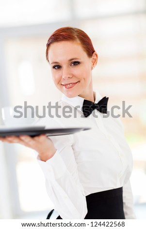 beautiful young waitress serving coffee in restaurant