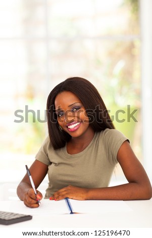 pretty african american college student studying at home