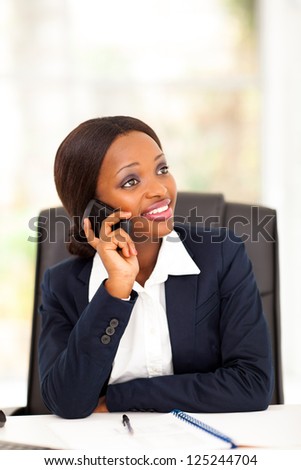 pretty african american office worker talking on cell phone