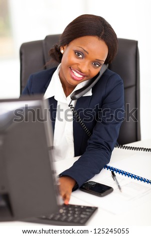 pretty female african corporate worker working in office