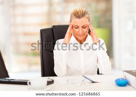 elegant female middle aged office worker resting in office