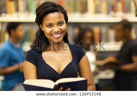 happy female african american college student in library