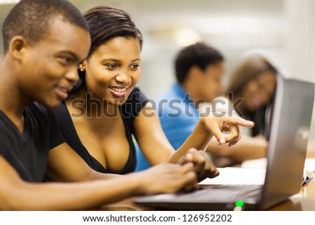 african american college students using laptop computer
