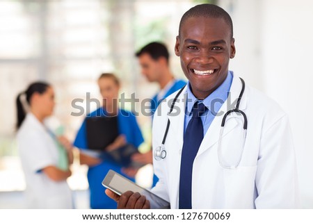 handsome african american healthcare worker with tablet computer