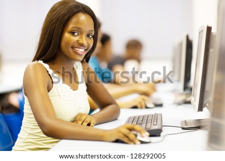 pretty african american college student in computer room