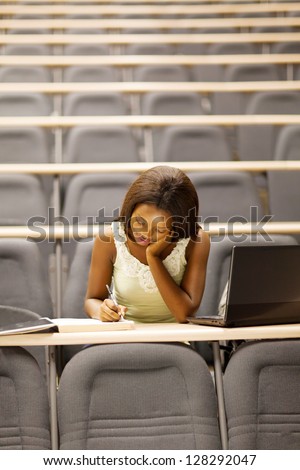 female african american university student sitting in lecture room
