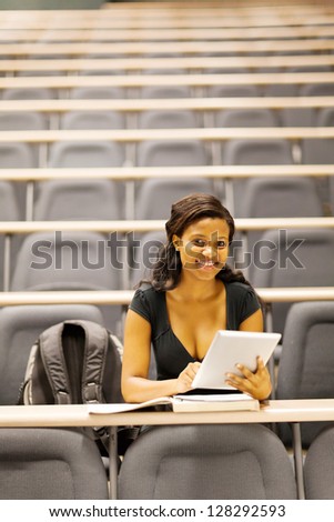 female african american college student in lecture hall with tablet computer