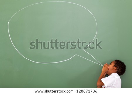 elementary schoolboy shouting at chat box drawn on chalkboard