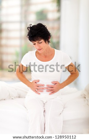 middle aged woman having constipation problem