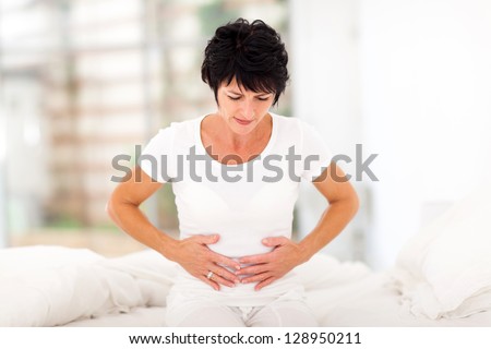 Mid Age Woman Having Stomach Pain At Home