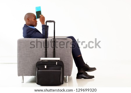 tired african american businessman resting in airport VIP lounge