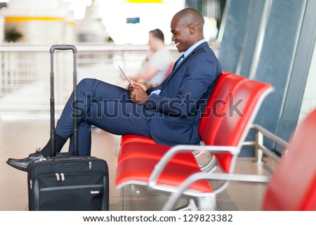 modern african businessman using tablet computer at airport
