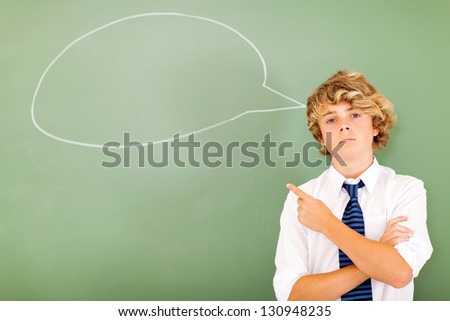 high school boy pointing at chat box drawn on blackboard