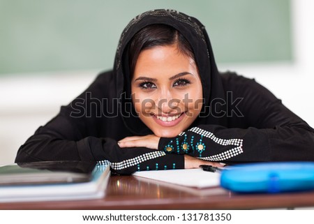 smiling Muslim female high school student in classroom