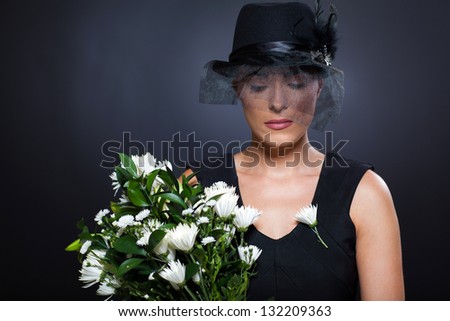 sad young widow with black mourning hat and flowers