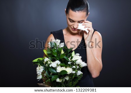 sad young woman in mourning clothes and crying