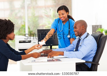 caring nurse handover tissue to sick patient in doctor\'s office
