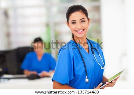 beautiful young medical worker holding tablet computer