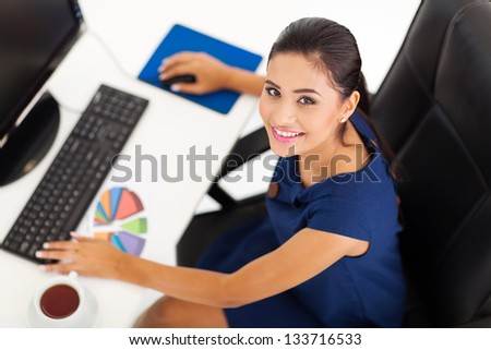 overhead view of female corporate worker working by her desk