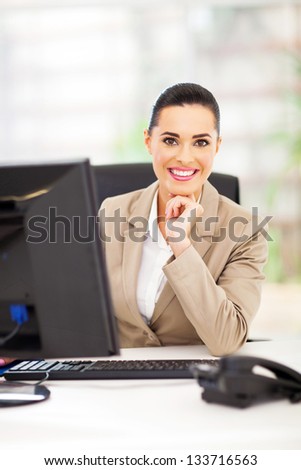 happy career woman in office smiling