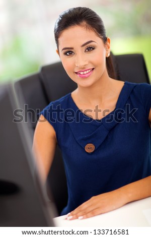 pretty female office worker by her work station