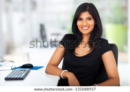 lovely young businesswoman sitting in modern office