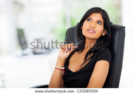 lovely thoughtful young businesswoman looking up