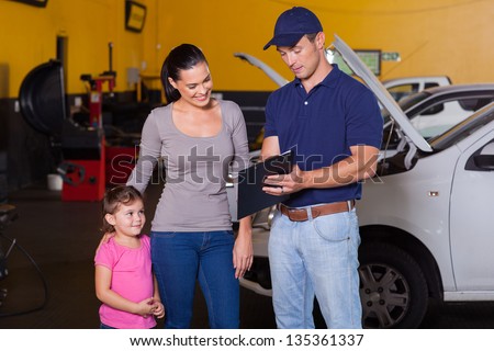 mother and daughter in garage with auto mechanic