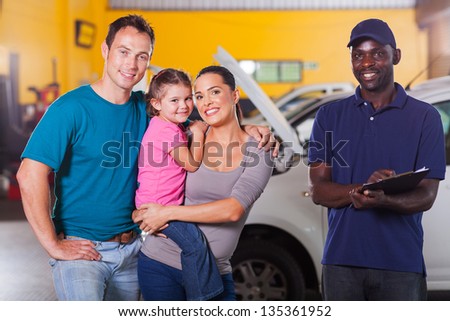 happy family in garage with auto mechanic