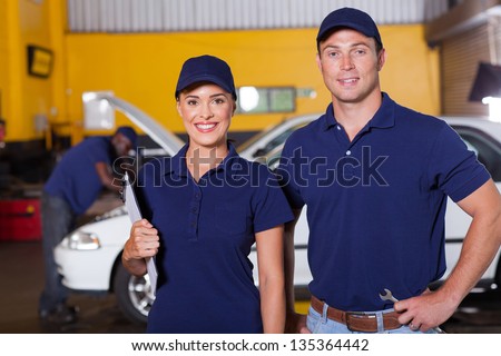 two happy auto service center employees portrait inside workshop