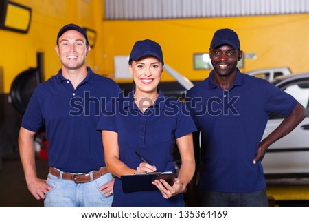 group of happy workers in auto repair shop
