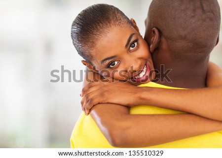 beautiful african girl hugging her boyfriend