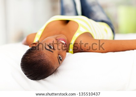 attractive african woman lying on bed