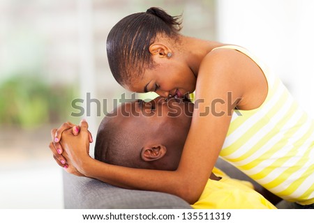 young african american couple kissing and flirting