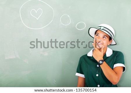 cute high school girl thinking about love in classroom