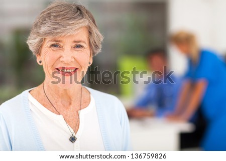 portrait of smiling senior woman in doctor\'s office