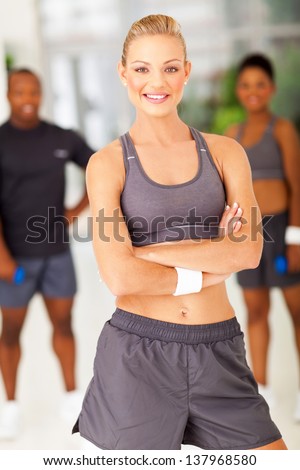 attractive fit woman posing with arms folded